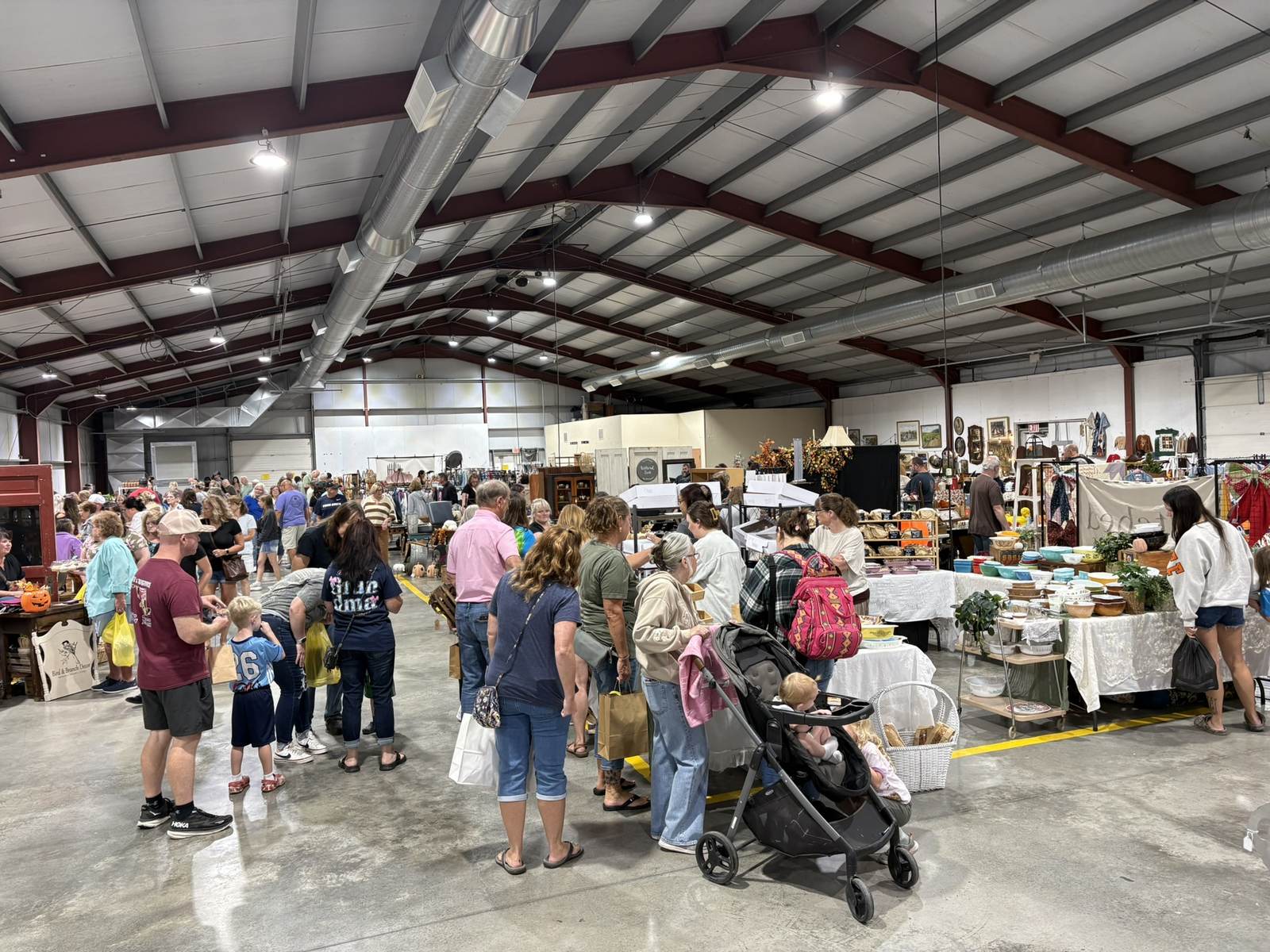 Crowded aisle of shoppers browsing vendor booths at Finley Bee at the Fairgrounds Harvest Market, Bedford PA
