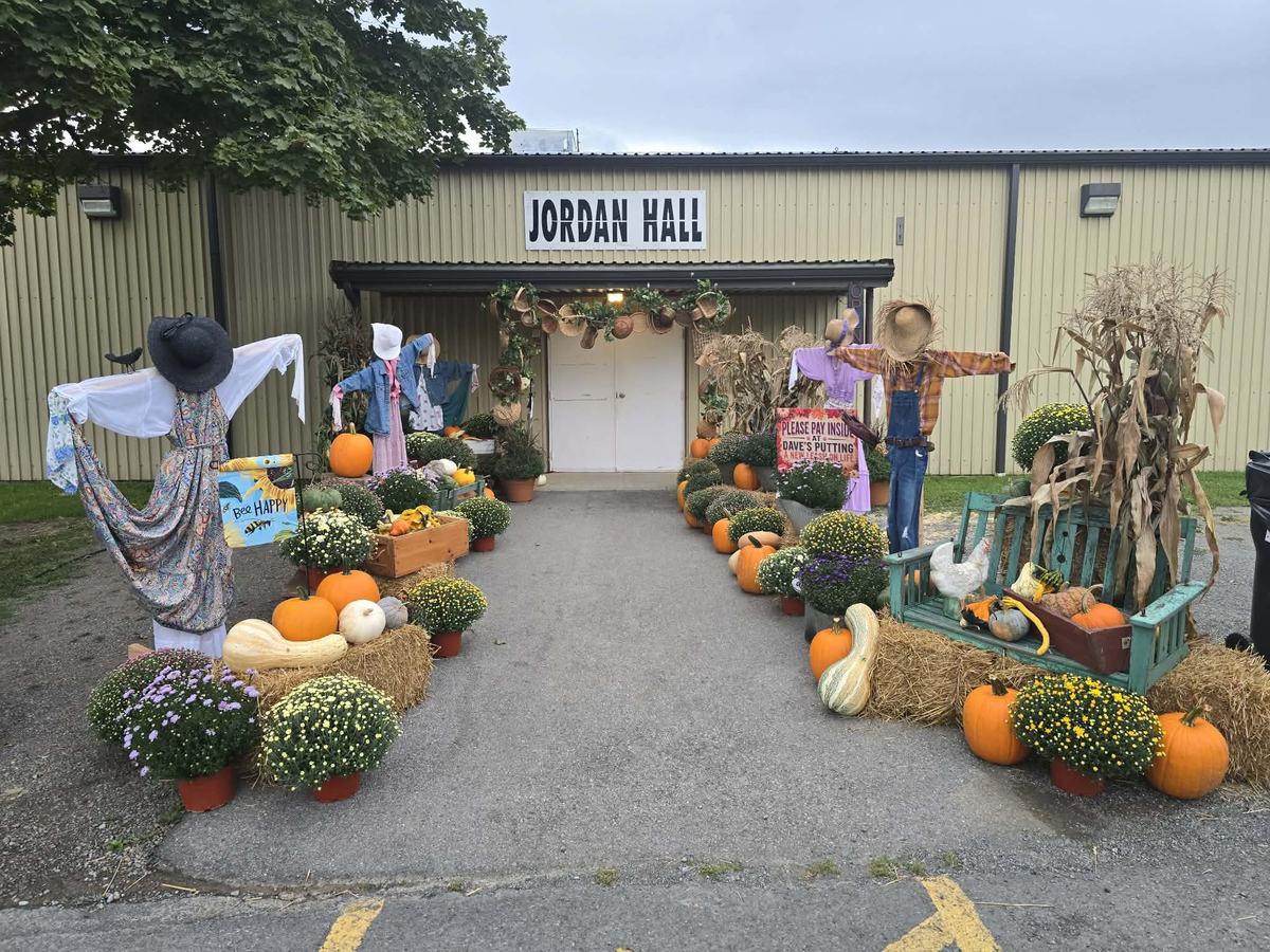 Fall entrance display with scarecrows and pumpkins at Jordan Hall, Bedford County Fairgrounds